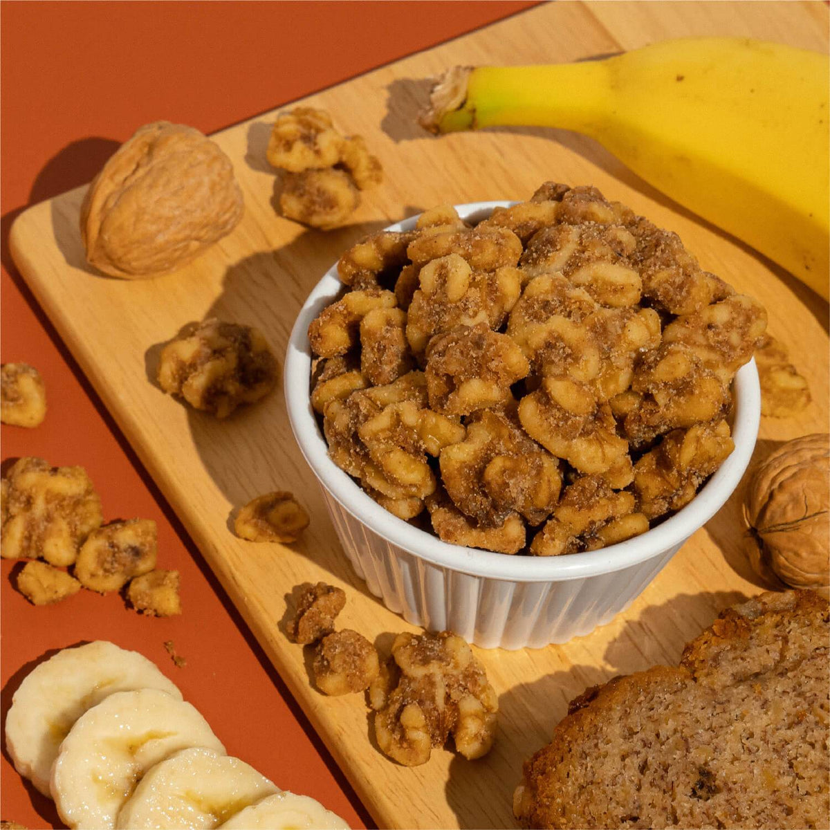 Bowl of banana bread walnuts with sliced bananas and banana bread