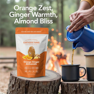 Orange Ginger Almonds pouch on a stump by a campfire with coffee