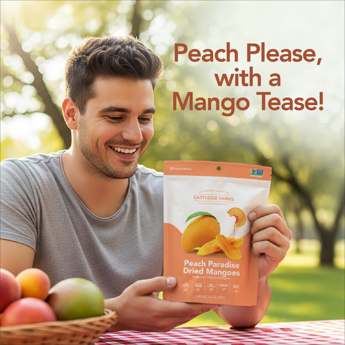 Smiling man at a picnic holding a Peach Paradise Dried Mangoes pouch