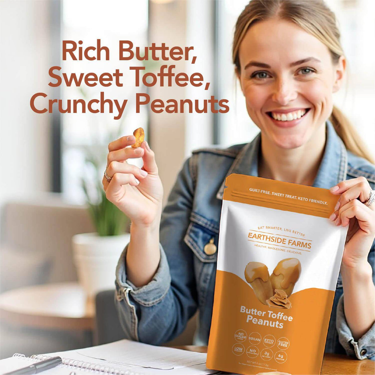 Smiling woman eating peanuts and holding a Butter Toffee Peanuts pouch