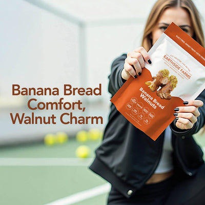 Woman on a tennis court holding a Banana Bread Walnuts pouch